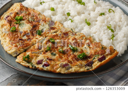 Motta Porichathu or Spicy Coconut Ginger Omelette, is a flavorful dish from Kerala, India closeup on the plate. Horizontal 126353009