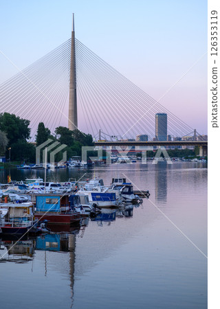 Boat marina at Ada Ciganlija with Ada Bridge, a cable-stayed bridge over the Sava river in Belgrade, Serbia Boat marina at Ada Ciganlija with Ada Bridge, a cable-stayed bridge over the Sava river in Belgrade, Serbia 126353119