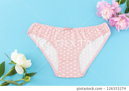 Pink cotton women's panties on the blue background. 126353274