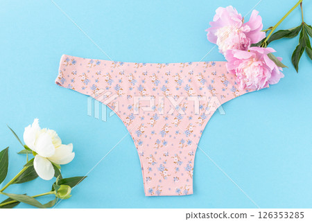 Pink cotton women's panties on the blue background. 126353285