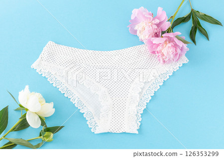 White cotton women's panties on the blue background. 126353299