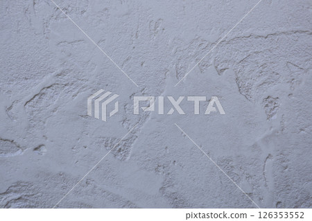 Background of a wall with patterned putty covered with paint. Abstract texture of surface covered with putty. Background of a wall with patterned putty covered with paint. Abstract texture of surface covered with putty. 126353552