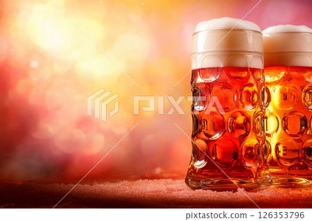 Enjoying foamy beer in large glass goblets during Oktoberfest celebration in a festive atmosphere 126353796
