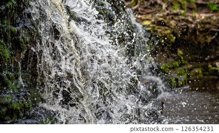 Closeup of falling and splashing streams of water, Ivande waterfall, Latvia Closeup of falling and splashing streams of water, Ivande waterfall, Latvia 126354231