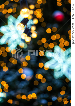 Christmas tree with yellow garlands lights and bokeh copy space Christmas tree with yellow garlands lights and bokeh copy space 126354232