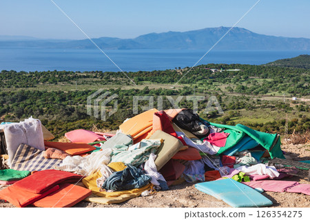 Illegally dumped household waste on scenic hillside above Aegean Sea 126354275