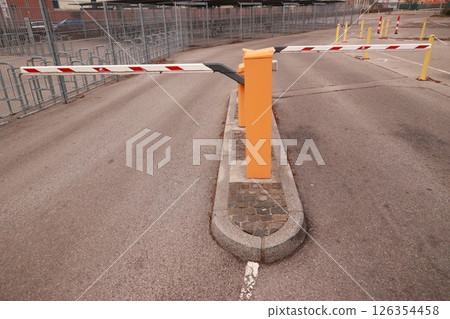 Yellow and orange traffic barrier with red and white stripes Yellow and orange traffic barrier with red and white stripes 126354458