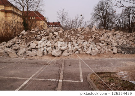 Pile of rocks is sitting in a parking lot 126354459