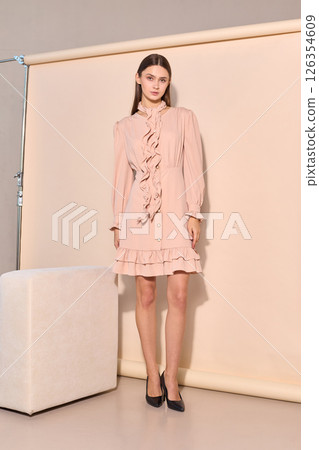 beautiful fashion female model in short beige dress beautiful fashion female model in short beige dress 126354609