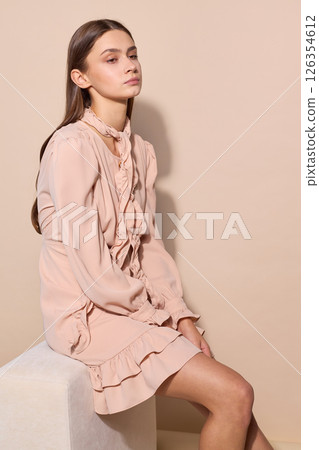 beautiful fashion female model in short beige dress 126354612
