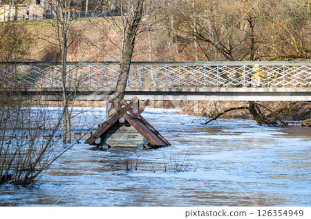 to the roof flooded in spring floods bird house - feeder in the river near the pedestrian bridge 126354949