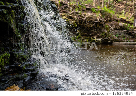 Closeup of falling and splashing streams of water, Ivande waterfall, Latvia Closeup of falling and splashing streams of water, Ivande waterfall, Latvia 126354954