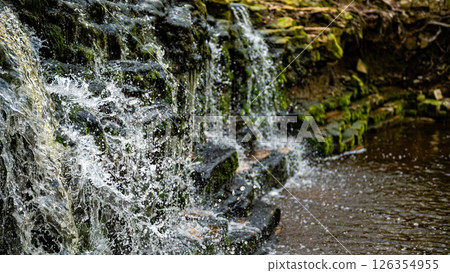 Closeup of falling and splashing streams of water, Ivande waterfall, Latvia 126354955