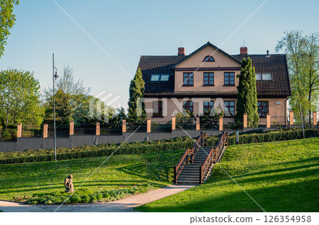 Kuldiga Old Town Park with walking paths and adjacent buildings, Kuldiga, Latvia Kuldiga Old Town Park with walking paths and adjacent buildings, Kuldiga, Latvia 126354958