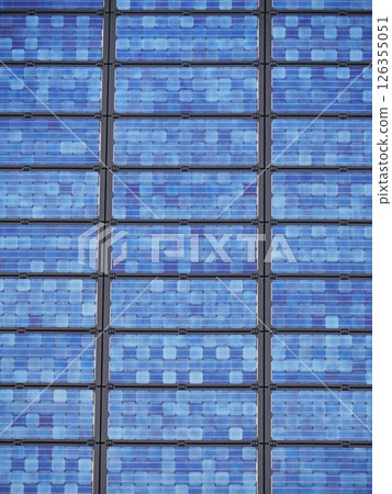 A blue building with solar panels on the roof 126355051