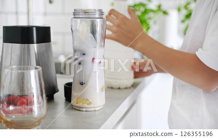 Little Girl Making A Milkshake And Shaking It With A Sport Shaker 126355196