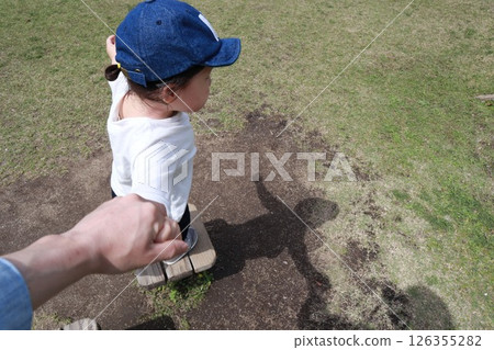 Parent and child holding hands and walking 126355282
