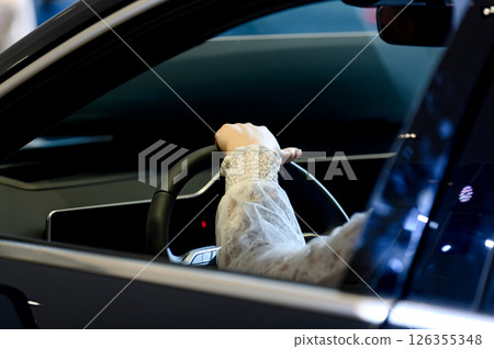 close-up of a man sitting behind the wheel of a new car 126355348