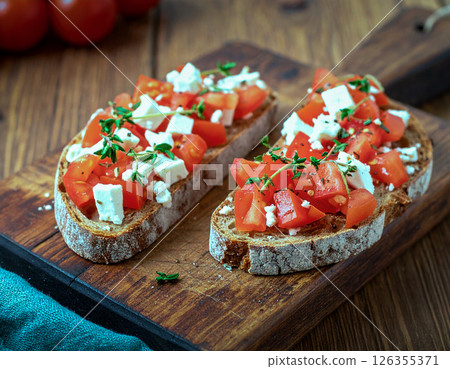 Toast topped with feta cheese and tomato 126355371