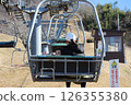 Parent and child riding a lift 126355380