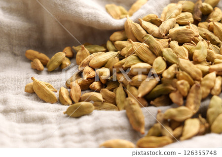 Dried Indian cardamom spice on cloth napkin close up 126355748