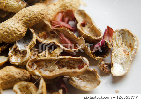 Empty nutshells of eaten peanuts as waste for recycling. Macro shot.  126355777