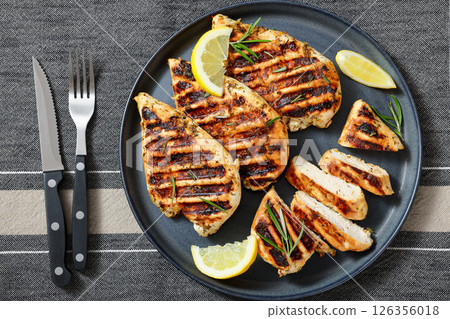 grilled chicken breast with lemon on a plate grilled chicken breast with lemon on a plate 126356018