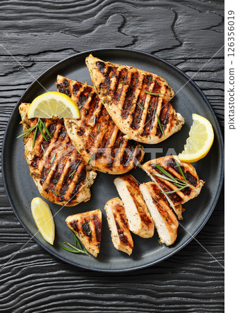 grilled chicken breast with lemon on a plate grilled chicken breast with lemon on a plate 126356019