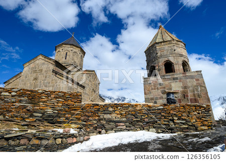Gergeti Trinity Church near the village of Stepantsminda, popular tourist destination in the Caucasus in Georgia Gergeti Trinity Church near the village of Stepantsminda, popular tourist destination in the Caucasus in Georgia 126356105