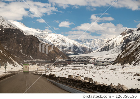 Trucks drive through mountain passes on the Georgian Military Road, major route through the Caucasus from Georgia to Russia 126356150