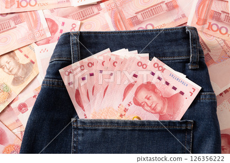 Chinese yuan 100 banknotes in jeans back pocket. Chinese paper currency Yuan renminbi banknotes as background. 126356222