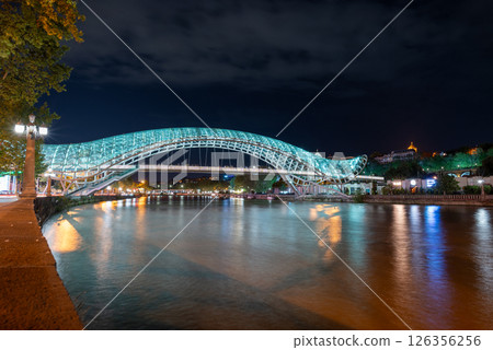 Peace bridge, steel and glass construction pedestrian bridge over Kura Mtkvari river in central Tbilisi, capital of Georgia Peace bridge, steel and glass construction pedestrian bridge over Kura Mtkvari river in central Tbilisi, capital of Georgia 126356256