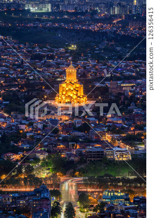 Night view of illuminated Holy Trinity Cathedral and the cityscape of Tbilisi, the capital of Georgia 126356415