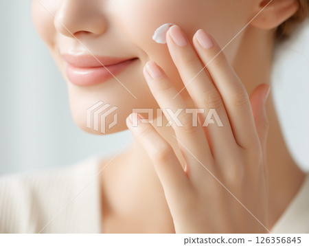 Hands of a Japanese woman applying moisturizing cream to her face as part of skin care Hands of a Japanese woman applying moisturizing cream to her face as part of skin care 126356845