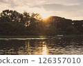 Sunset over the river a peaceful evening scene in countryside. 126357010