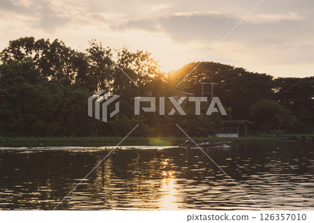 Sunset over the river a peaceful evening scene in countryside. 126357010