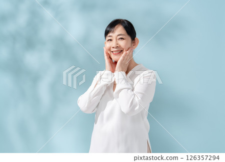 Beauty sunshine filtering through trees Senior woman 126357294