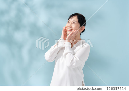 Beauty sunshine filtering through trees Senior woman 126357314