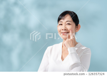 Beauty sunshine filtering through trees Senior woman 126357324