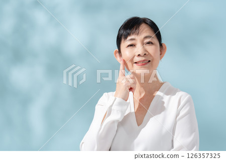 Beauty sunshine filtering through trees Senior woman 126357325
