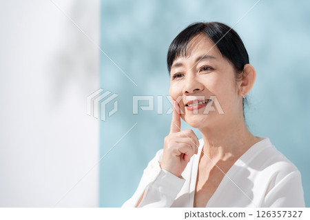 Beauty sunshine filtering through trees Senior woman 126357327