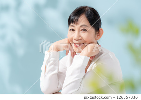 Beauty sunshine filtering through trees Senior woman 126357330