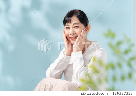 Beauty sunshine filtering through trees Senior woman 126357335
