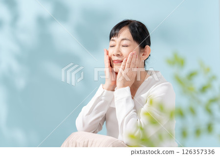 Beauty sunshine filtering through trees Senior woman 126357336