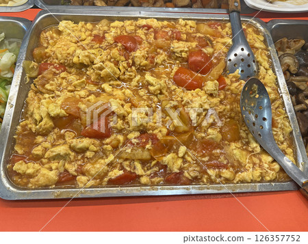 Photographing Taiwanese style fried tomato eggs on a plate at a vegetarian buffet restaurant Photographing Taiwanese style fried tomato eggs on a plate at a vegetarian buffet restaurant 126357752