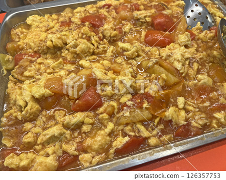 Photographing Taiwanese style fried tomato eggs on a plate at a vegetarian buffet restaurant Photographing Taiwanese style fried tomato eggs on a plate at a vegetarian buffet restaurant 126357753