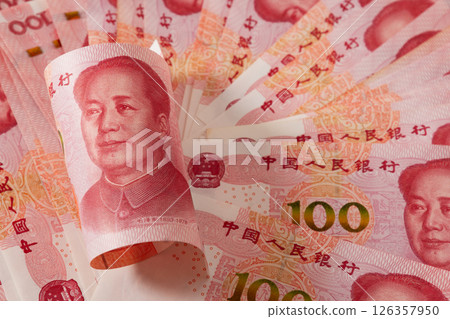 Roll of Chinese yuan 100 banknotes. Chinese paper currency Yuan renminbi banknotes as background. Close up. Roll of Chinese yuan 100 banknotes. Chinese paper currency Yuan renminbi banknotes as background. Close up. 126357950