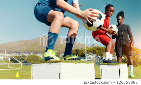 Children, jumping and ball for soccer practice for fitness training, balance exercise and sports drill. Kids, box and equipment for playing game, learning skills and team challenge for match activity Children, jumping and ball for soccer practice for fitness training, balance exercise and sports drill. Kids, box and equipment for playing game, learning skills and team challenge for match activity 126358065