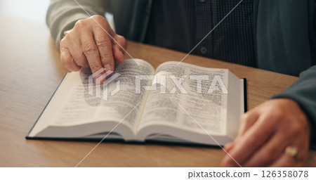 Hands, bible study and faith in home, retirement and reading with scripture, info and spiritual knowledge. Elderly person, book and religion with language, learning and gospel for God at apartment 126358078