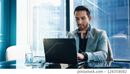 Finance, laptop and typing with business man in office of investment firm for portfolio growth. Computer, money and wealth with serious broker in corporate workplace for planning, research or trading 126358082